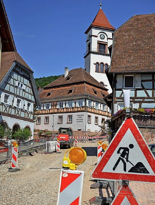 Baustelle mit Warnschild vor Fachwerkhäusern im Ortskern
